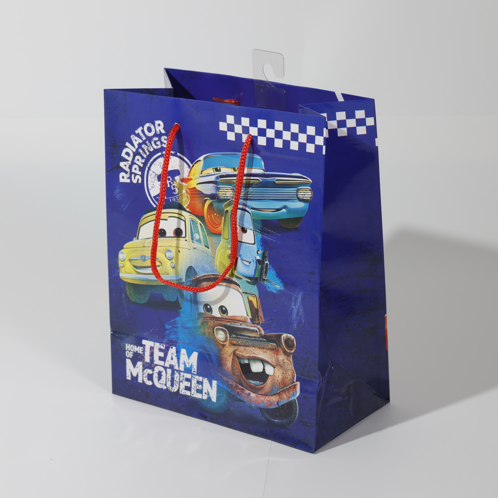 Disney·Pixar Cars Team McQueen — gloss-laminated licensed retail paper bag with rope handles and hang tab